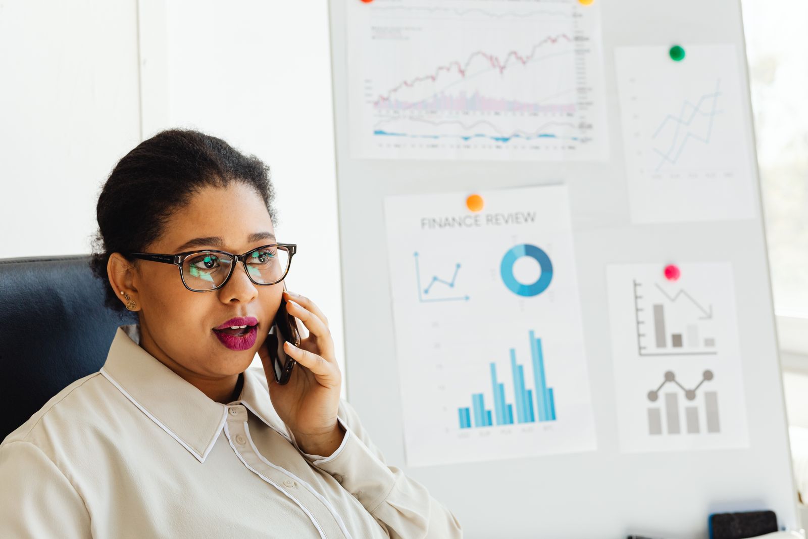 African finance professional reviewing performance charts and financial data